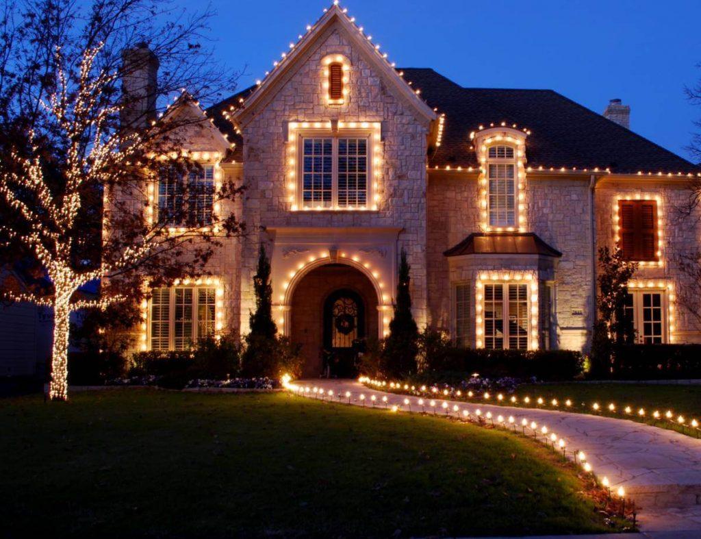 big brick house with white Christmas lights